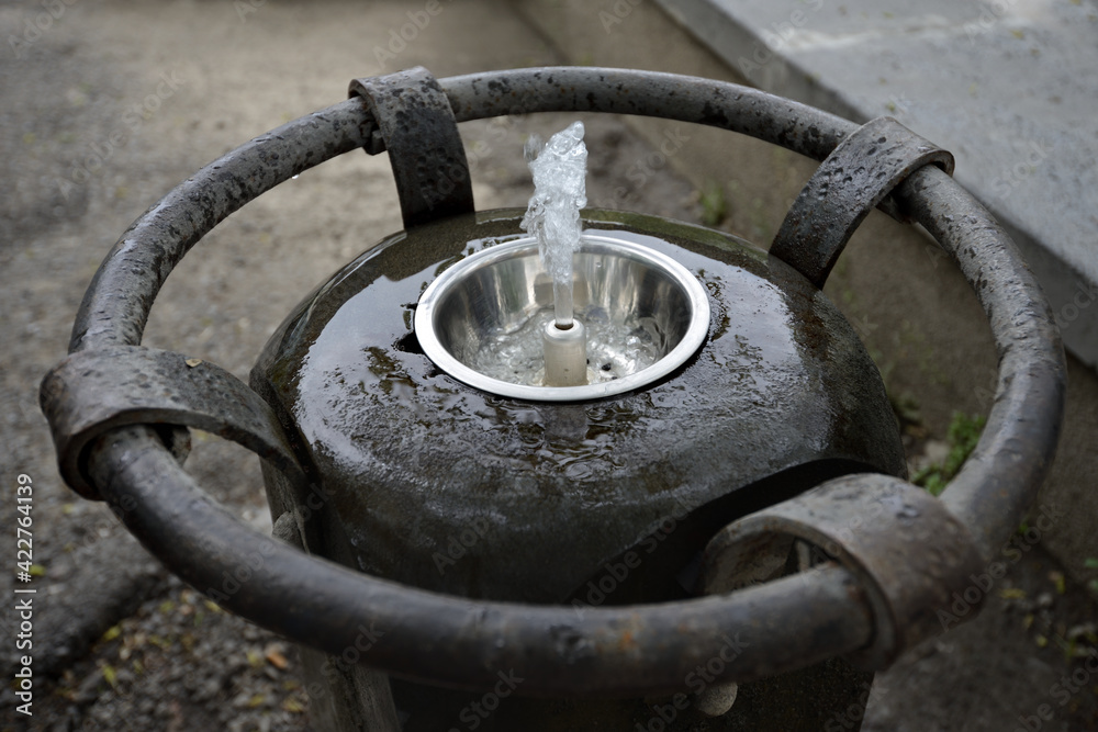 Outdoor fountain with a metal base with clean water for drinking. Public drinking water. A stream of water from the fountain. fountain outside with clean drinking water Outdoor fountain with a metal base with clean water for drinking. Public drinking water. A stream of water from the fountain. fountain outside with clean drinking water