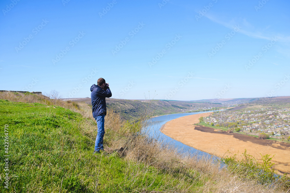 young photographer making landscape pictures