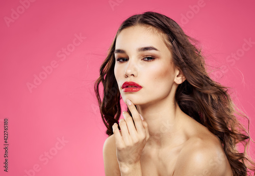 Woman model brunette on pink background bare shoulders cropped view