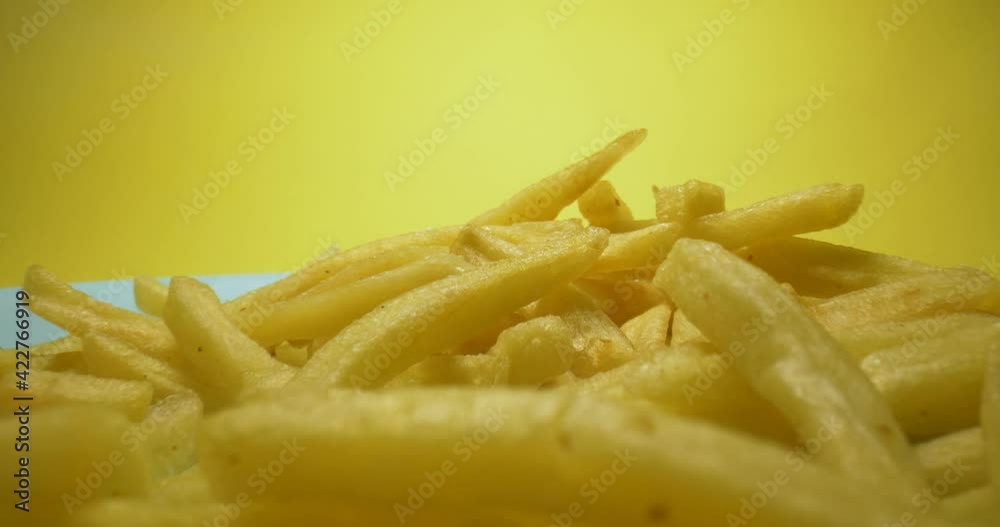 detailed extreme close-up of hot fries with smoke on yellow background. detailed extreme close-up of hot fries with smoke on yellow background.