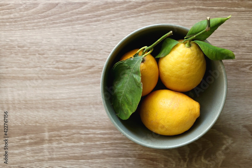 Bowl of lemons on a table. Flat lay.