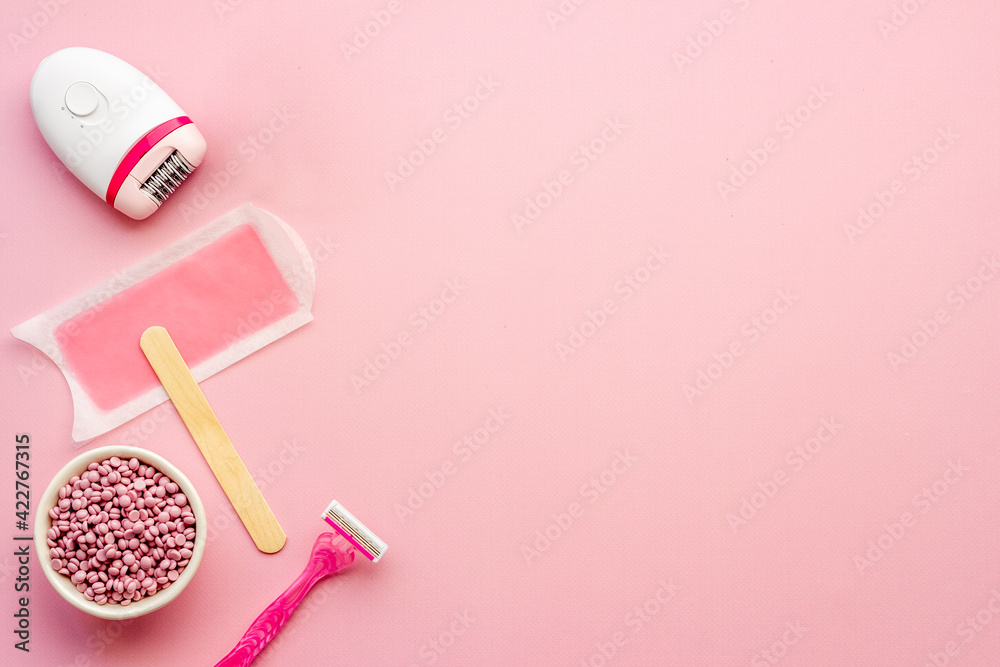 Set for epilation - epilator with wax strips and razor. Top view, flat lay Set for epilation - epilator with wax strips and razor. Top view, flat lay