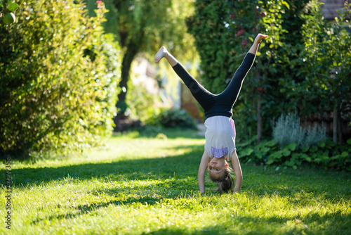 Kid doing cartwheel in backyard