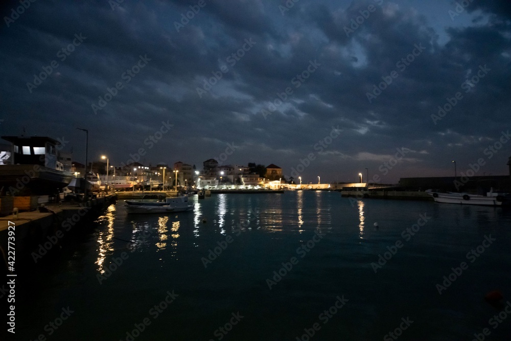 Batroun harbor in Lebanon at night with dramatic cloud sky