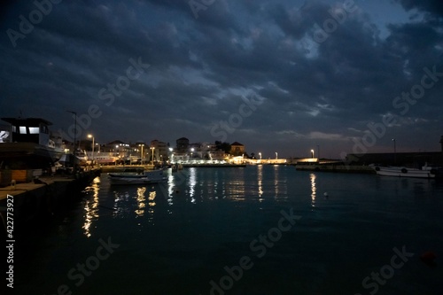 Batroun harbor in Lebanon at night with dramatic cloud sky