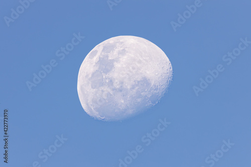 Moon in the afternoon on blue sky background