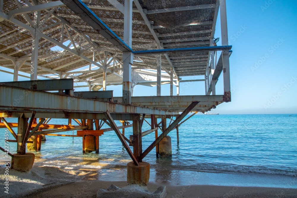 wrecked and abandoned metal frame of a pier in the Mediterranean sea wrecked and abandoned metal frame of a pier in the Mediterranean sea