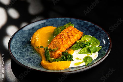 Grilled red fish fillets. Salmon with vegetable puree and spinach.