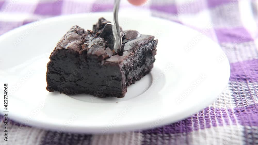 slice of homemade brownie on plate on table slice of homemade brownie on plate on table