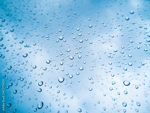 Rainwater drops Falling Down On the Window Glass, Rain Drops On The Windows Glass, Macro shot of water droplets falling.