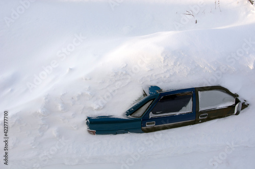 Car in the snow top view. The passenger car was covered with snow. A car in a snowdrift.