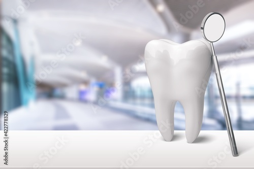 Human's white tooth and dentist mirror