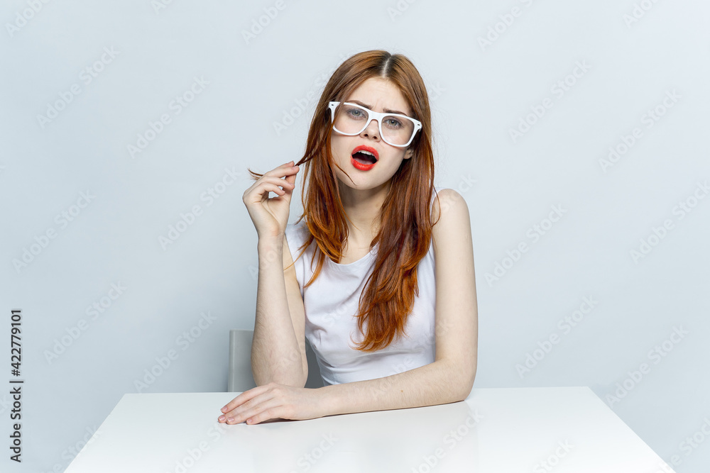 woman in white dress sitting at the table wearing glasses red lips woman in white dress sitting at the table wearing glasses red lips