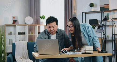 Wallpaper Mural Good-looking positive confident 30-aged chinese freelancers helping each other in joint project when revisioning it on computer and then giving high five Torontodigital.ca