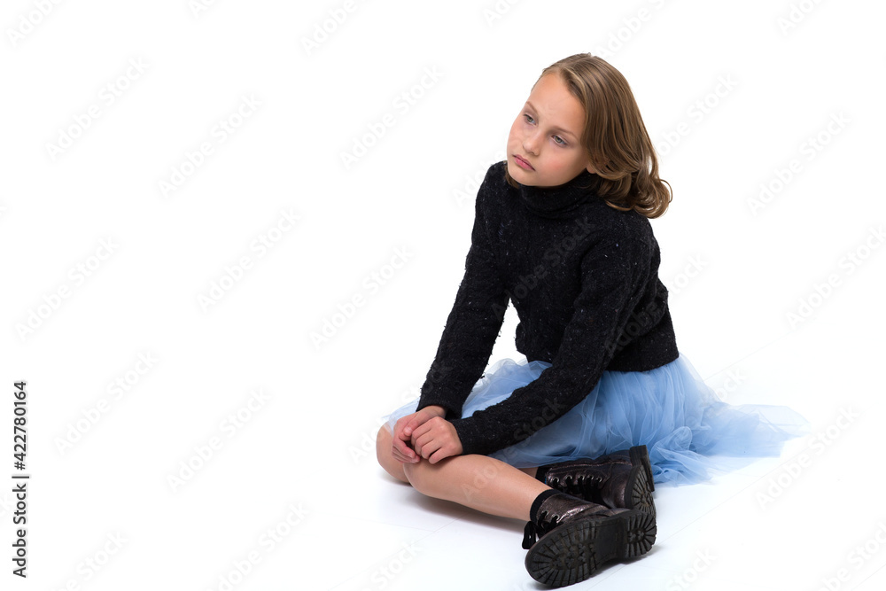 Pretty blonde sitting on the floor in the studio Pretty blonde sitting on the floor in the studio