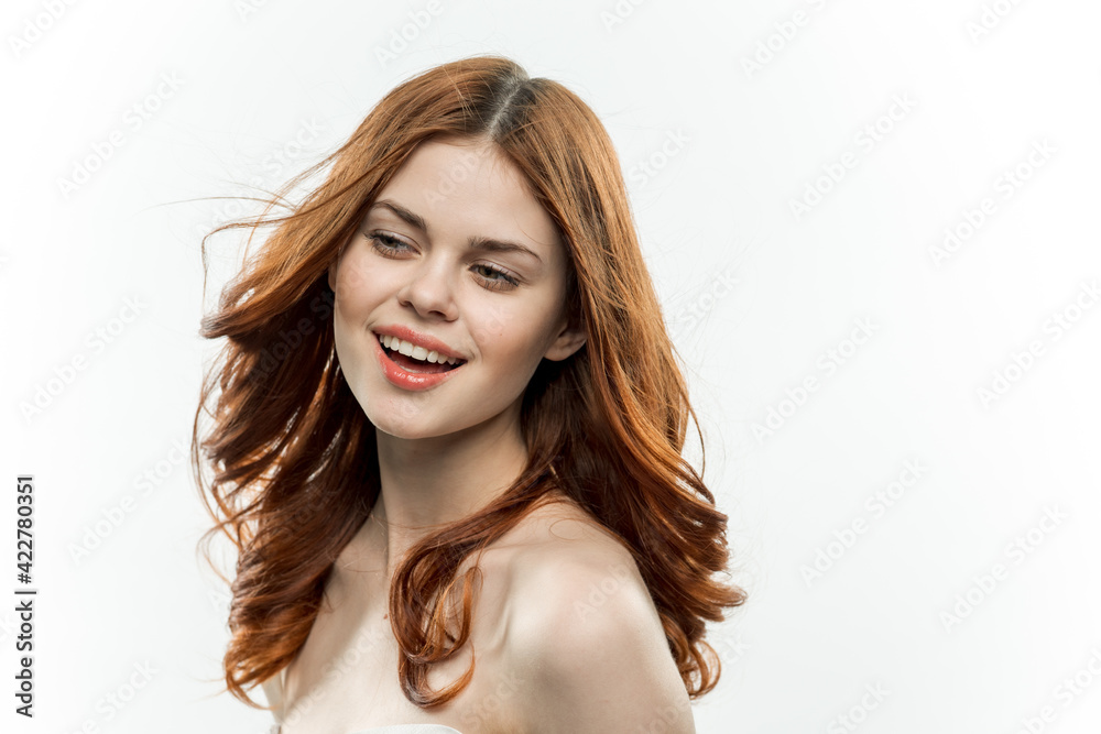 attractive red-haired woman with bare shoulders glamor cosmetics attractive red-haired woman with bare shoulders glamor cosmetics