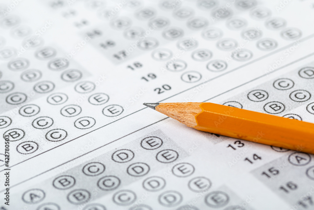 testing in exercise and exam paper. computer sheet with pencil in school test room, education concept. filling in answers in pencil testing in exercise and exam paper. computer sheet with pencil in school test room, education concept. filling in answers in pencil