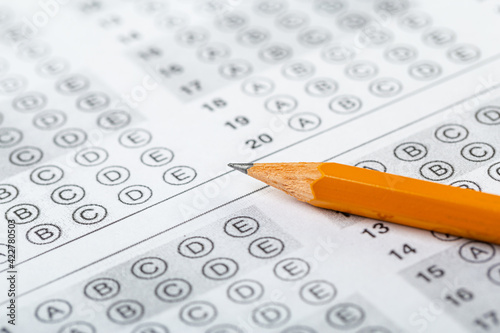 testing in exercise and exam paper. computer sheet with pencil in school test room, education concept. filling in answers in pencil