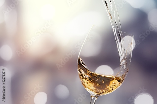 White wine being poured in a wineglass