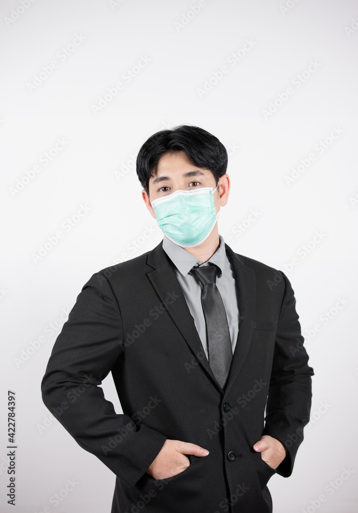 Handsome Asia young man with disposable face mask. Protection versus viruses and infection. Studio portrait, concept with white background. Businessman portrait. Handsome Asia young man with disposable face mask. Protection versus viruses and infection. Studio portrait, concept with white background. Businessman portrait.