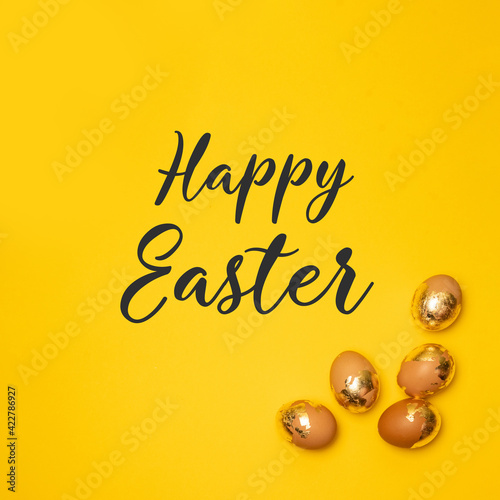 Golden eggs on a yellow background, top view, flat. Happy holiday celebrate © Shi 