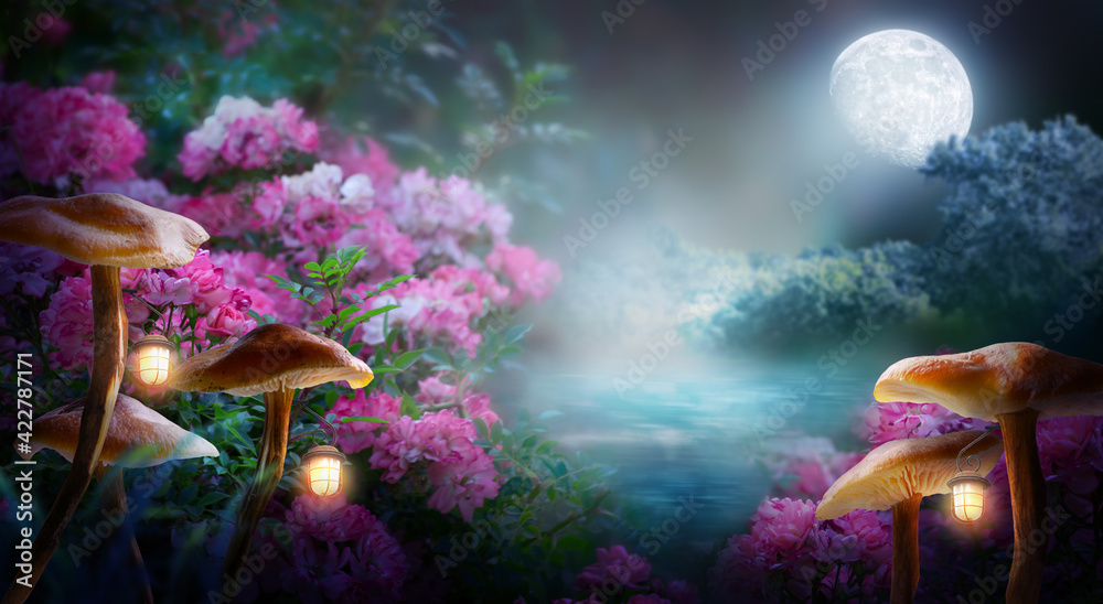 Fototapeta premium Fantasy mushrooms with lanterns in magical enchanted fairy tale landscape with forest lake, fabulous fairytale blooming pink rose flower garden on mysterious background, glowing moon ray in dark night