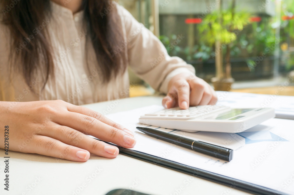 Calculating Cost Economic budget saving and investment concept.analyzing investment charts and calculator Accounting Concept Calculating Cost Economic budget saving and investment concept.analyzing investment charts and calculator Accounting Concept