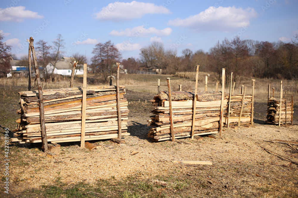 Drying pine planks in outdoor, in the countryside, on a sunny March day. Drying pine planks in outdoor, in the countryside, on a sunny March day.