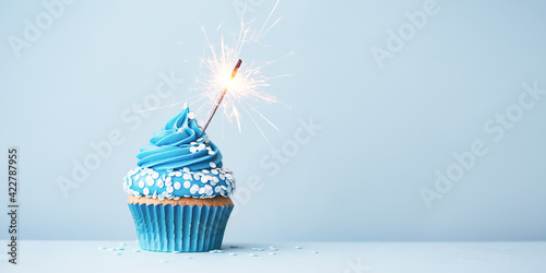 Blue celebration cupcake with sparkler and sprinkles