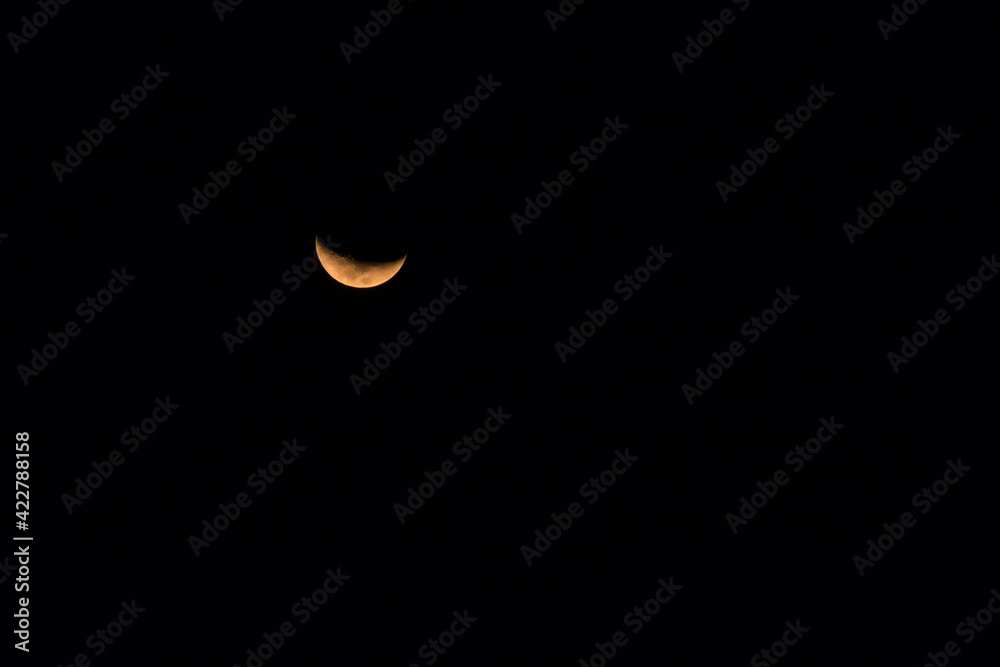 The half moon on black sky background at night. The half moon on black sky background at night.