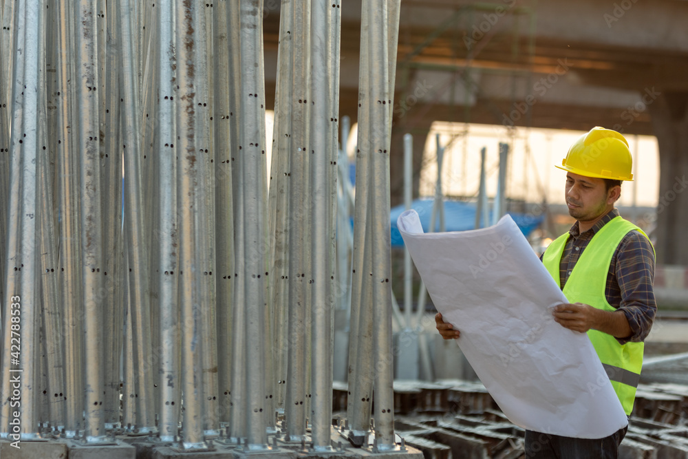 construction workers check drawings plan blueprint at construction site