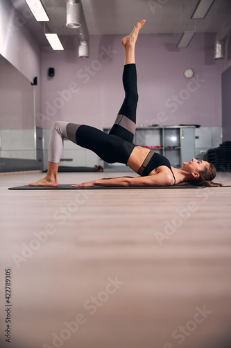 Attentive young woman doing sport in the gym