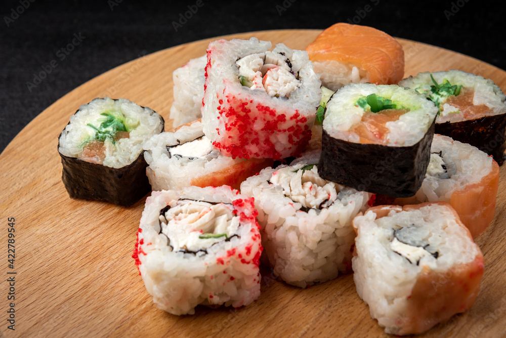 Sushi rolls on black background. Japanese food. Sushi rolls on black background. Japanese food.