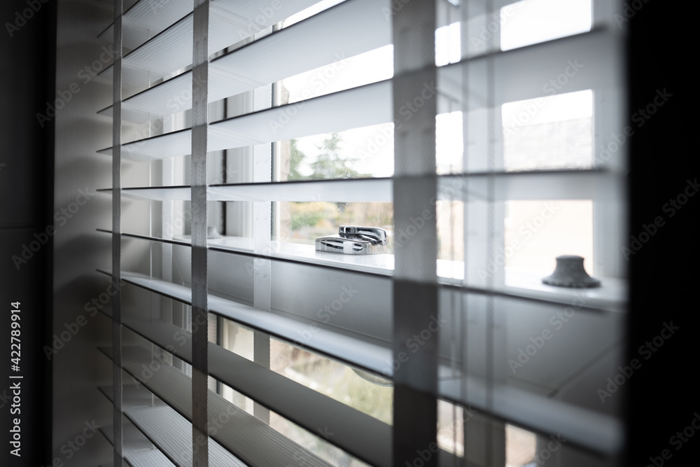 Shallow focus of a newly installed sash window, showing detail of the chrome lock system. Blinds are shown which aid privacy for the residence. Shallow focus of a newly installed sash window, showing detail of the chrome lock system. Blinds are shown which aid privacy for the residence.