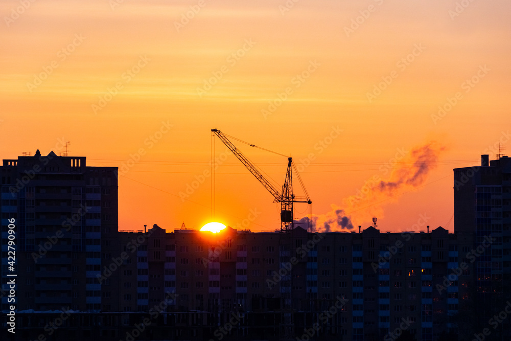 sunset over the construction site and the city