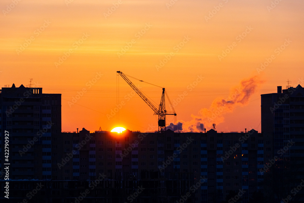 sunset over the construction site and the city sunset over the construction site and the city