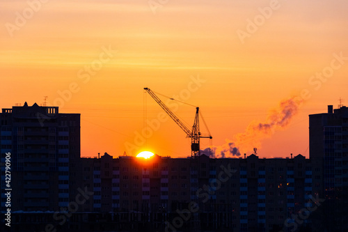 sunset over the construction site and the city