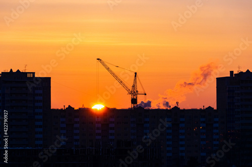 sunset over the construction site and the city