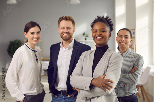 Business center employees. Portrait of a positive young multiracial team posing in the office looking at the camera. Concept of international relations and business. photo