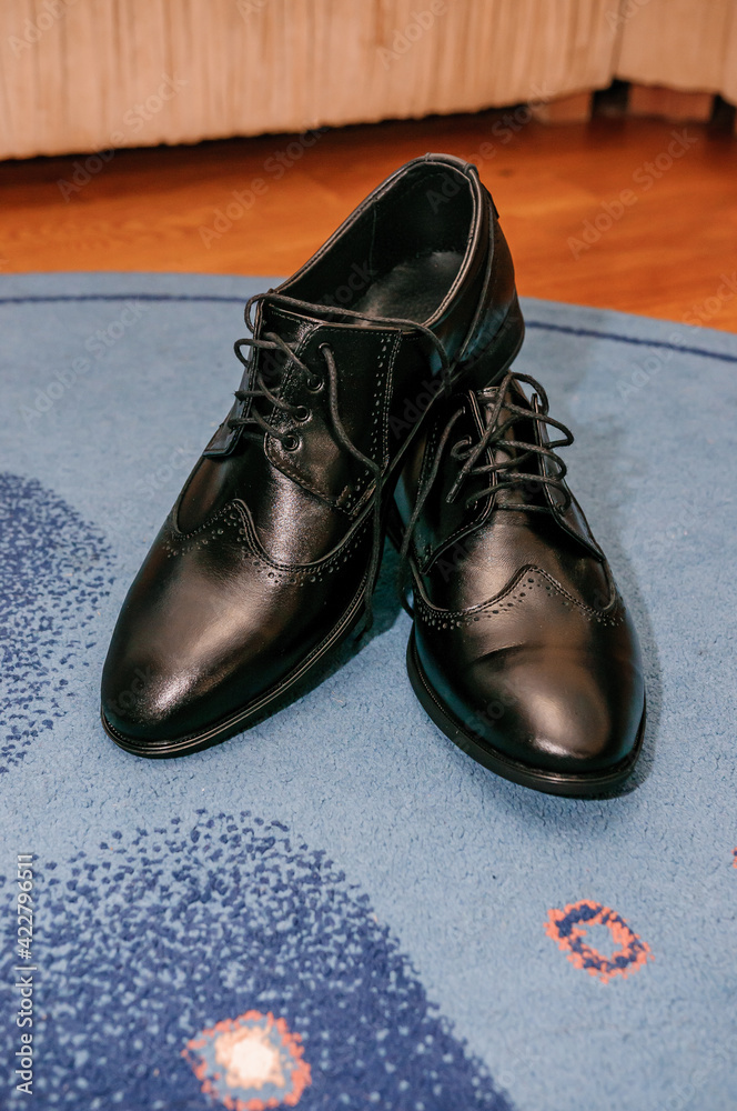 Black classic men's leather shoes stand on the floor