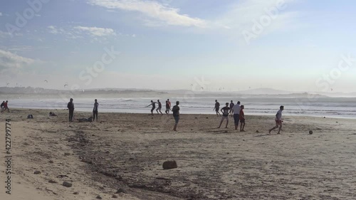 Group of young men play soccer on the beach in Esaaouira, Morocco. People, sand, sea, island, leisure, ball, sport, players. 4K Video Footage
