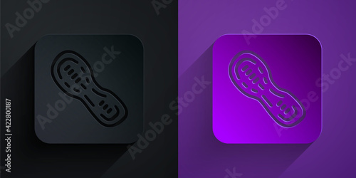 Paper cut Human footprints shoes icon isolated on black on purple background. Shoes sole. Paper art style. Vector