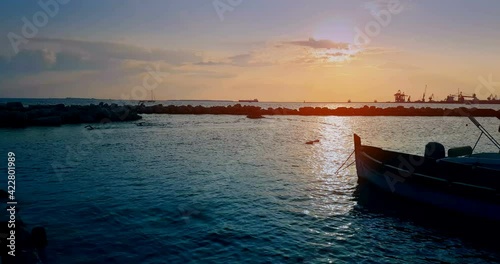 famous, beautiful beach at sunset with calm sea near Café del Mar, in summer very popular, sandy coast have a fantastic view of island of ibiza. Moored vessels on bay. Ibiza Island, Balearic Islands photo