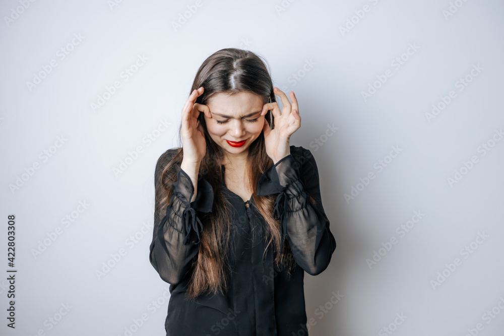 Portrait of a distressed woman on a light background Portrait of a distressed woman on a light background