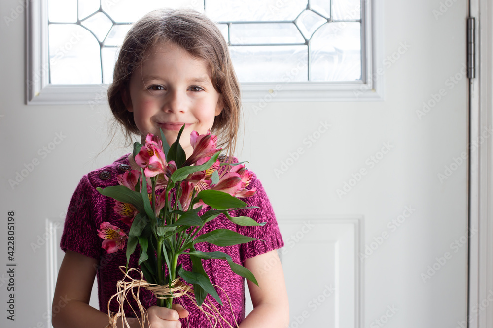 child holding a bouquet of flowers child holding a bouquet of flowers