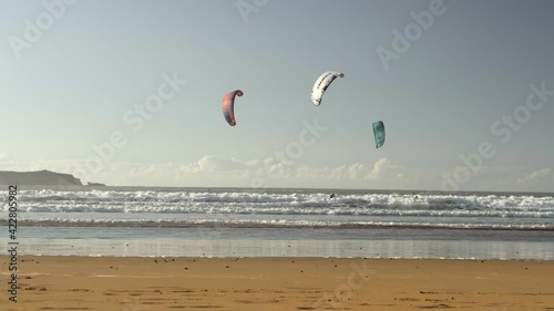 Kiteboarding activity in the waters of Morocco, Essaouira. Kiteboard, surfer, sea, ocean, waves, board, extreme sport, sportsman, summer, vacation / 4K Video Footage