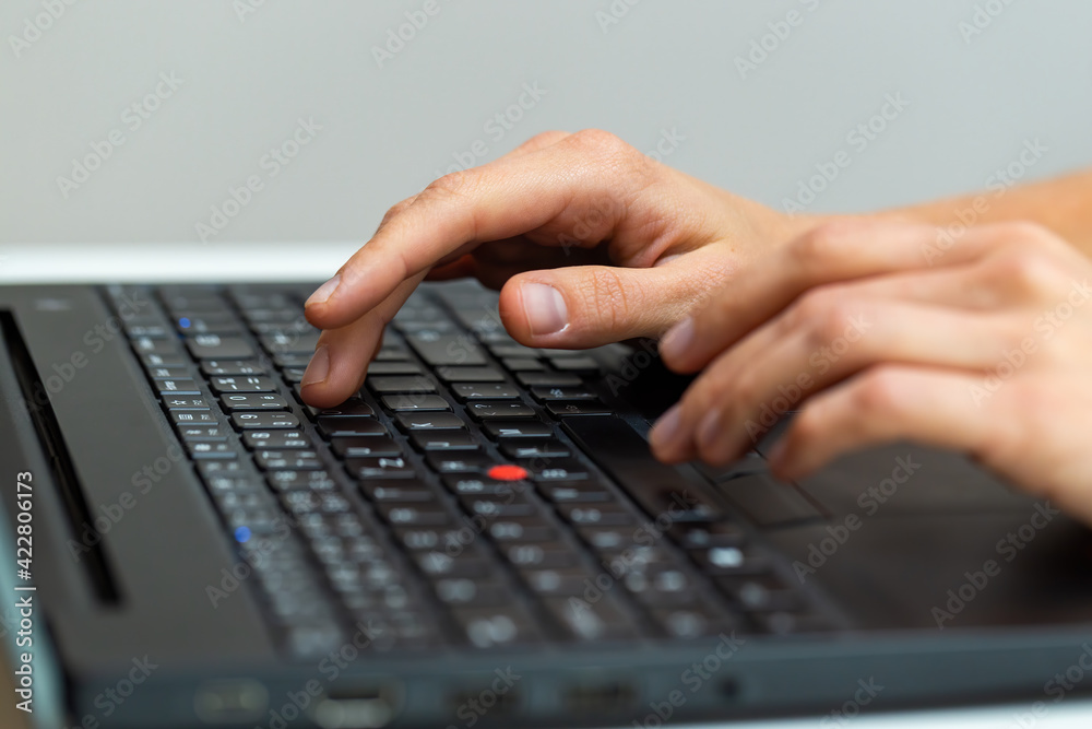 Human hand writting on laptop in office from close up Human hand writting on laptop in office from close up