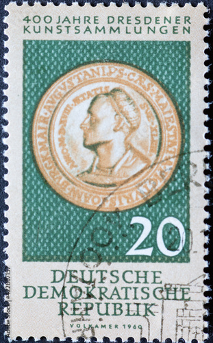 GERMANY, DDR - CIRCA 1960 : a postage stamp from Germany, GDR showing a foam coin (1518) with a portrait of the painter Hans Burgkmair (1473–1531). 400 years of Dresden art collections