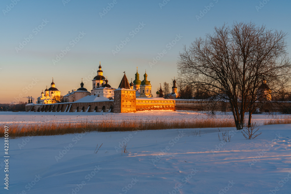 View of the Kirillo-Belozersky Monastery from the Siversky Lake in the rays of the setting sun on a frosty winter evening, Kirillov, Vologda region, Russia