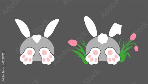 Drawn funny bunny, ears, paws and tail. Rabbit character. The hare is sticking out of the hole. The hare is hiding in tulip flowers.